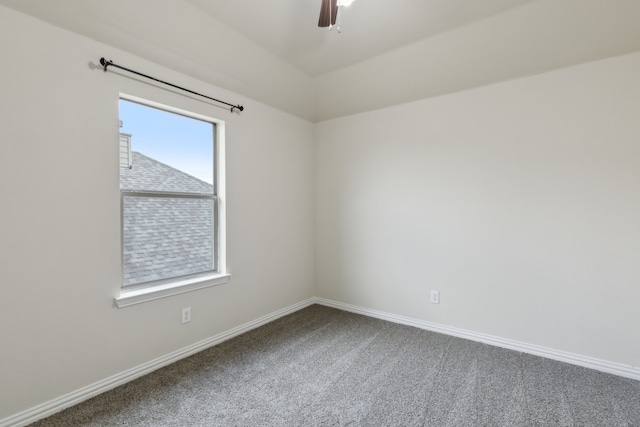 carpeted spare room with ceiling fan and baseboards