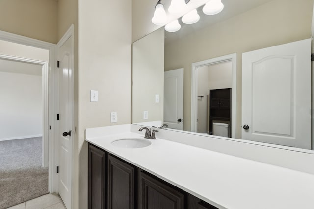 bathroom featuring toilet, tile patterned floors, and vanity