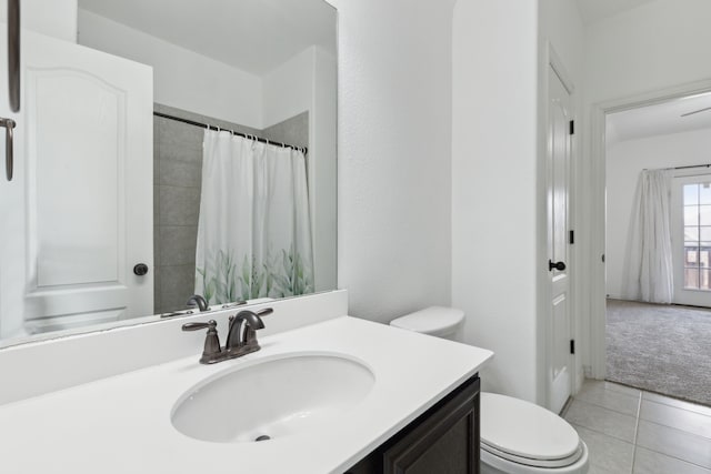 full bath with curtained shower, tile patterned flooring, vanity, and toilet