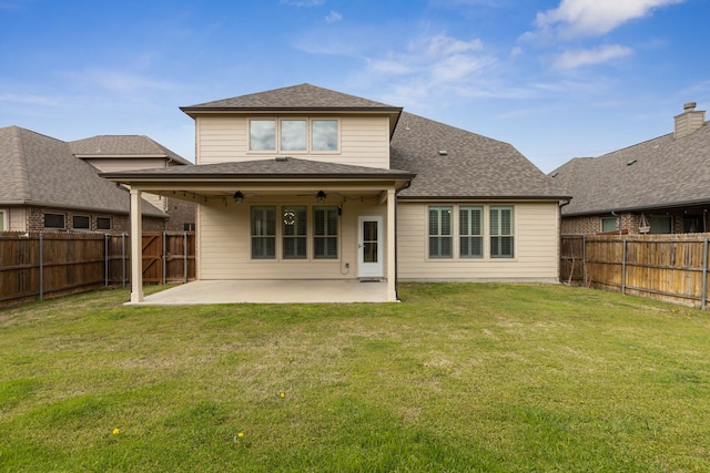 back of property with a patio area, a fenced backyard, ceiling fan, and a lawn