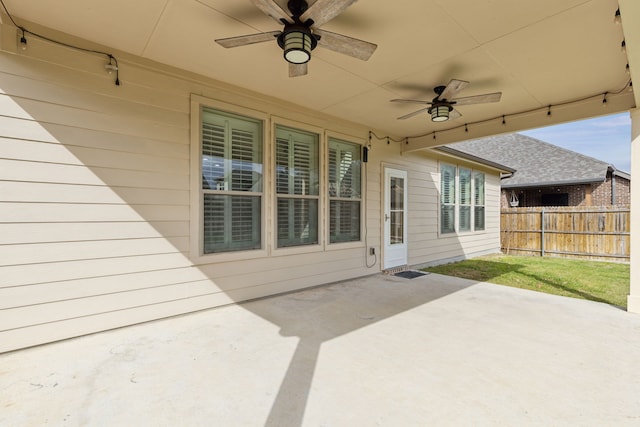 view of patio / terrace featuring ceiling fan and fence