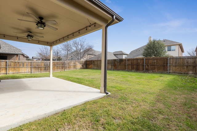 view of yard featuring a patio area, ceiling fan, and a fenced backyard