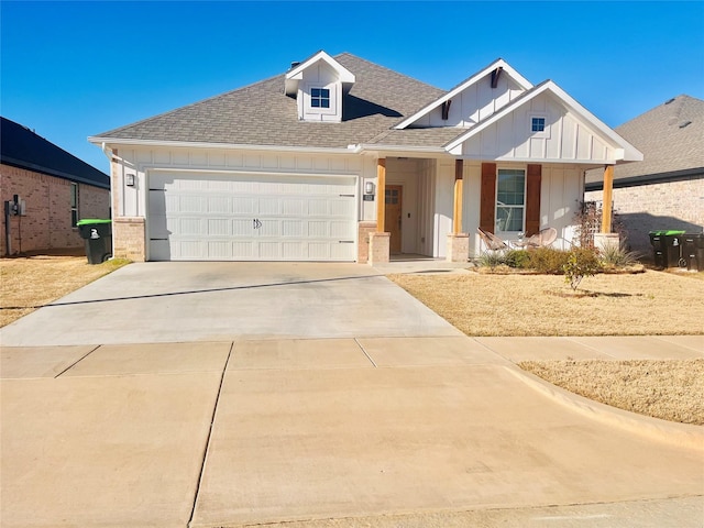 view of front of house featuring a garage, roof with shingles, board and batten siding, and driveway