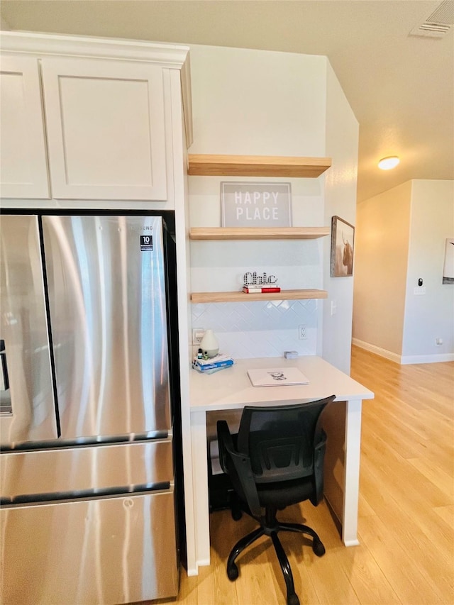 kitchen featuring visible vents, white cabinetry, freestanding refrigerator, open shelves, and light wood finished floors