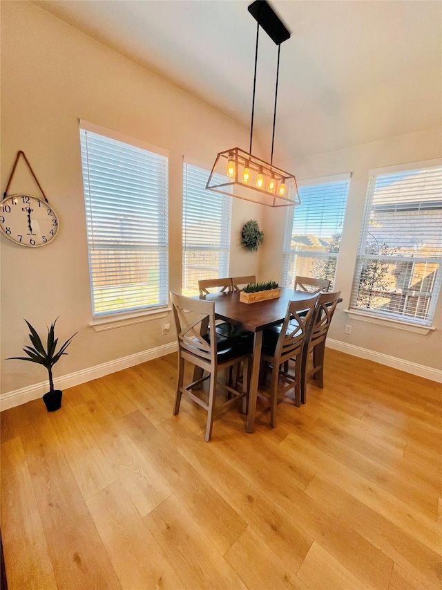 dining room with light wood-style flooring and baseboards