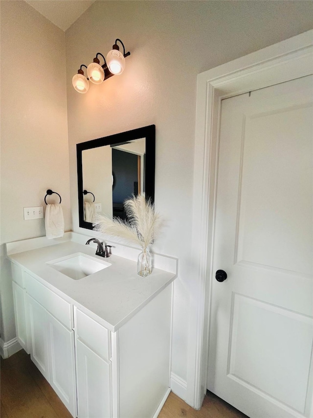 bathroom with baseboards and vanity