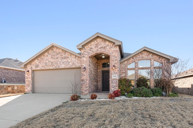 view of front of home featuring driveway, brick siding, and an attached garage