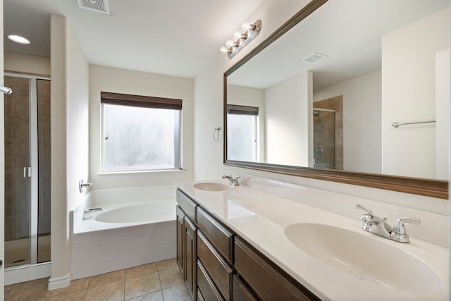 bathroom featuring a stall shower, tile patterned flooring, visible vents, and a sink