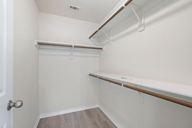 spacious closet featuring visible vents and light wood-style floors