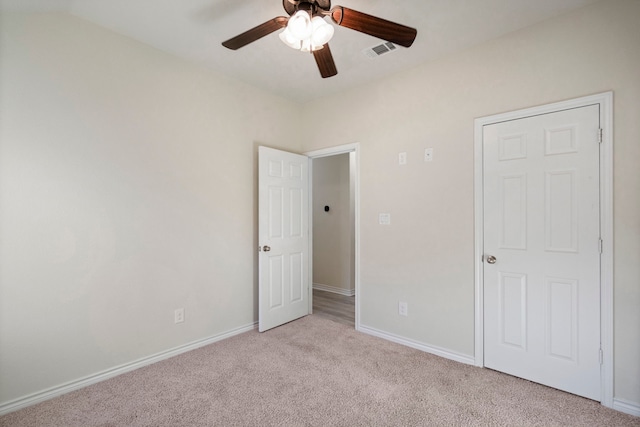 unfurnished bedroom featuring ceiling fan, carpet flooring, visible vents, and baseboards