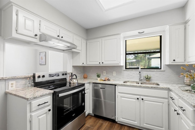 kitchen with under cabinet range hood, stainless steel appliances, a sink, white cabinetry, and dark wood finished floors