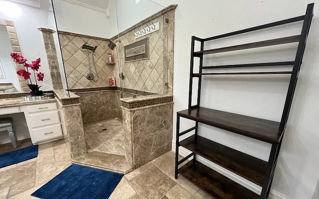 bathroom with stone finish flooring, a walk in shower, and vanity