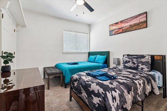 2616 NW Lambda Ln, Flower Mound, TX 75028 - carpeted bedroom with ornamental molding and ceiling fan