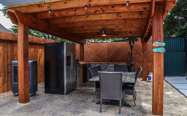 view of patio featuring outdoor dining space and fence