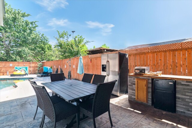 2616 NW Lambda Ln, Flower Mound, TX 75028 - view of patio / terrace with exterior kitchen, a fenced backyard, and outdoor dining space