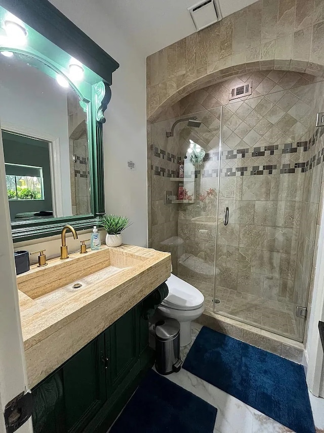 full bathroom with marble finish floor, visible vents, toilet, a stall shower, and vanity