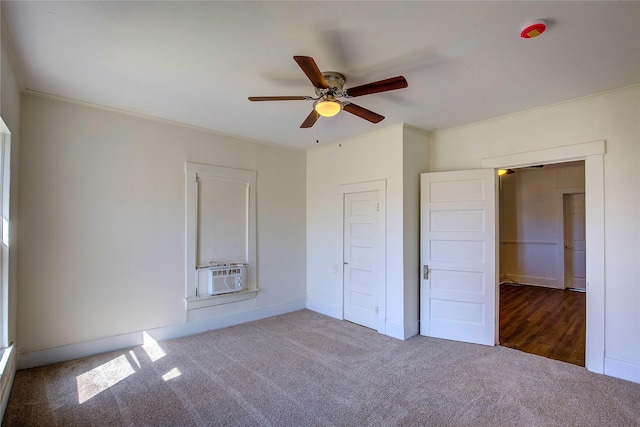 unfurnished bedroom with cooling unit, carpet flooring, a ceiling fan, and crown molding