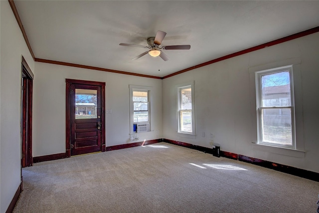 foyer entrance featuring carpet floors, ornamental molding, a ceiling fan, cooling unit, and baseboards