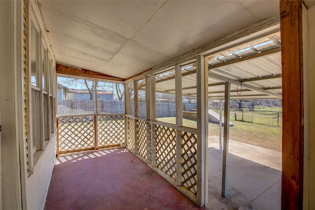 unfurnished sunroom featuring lofted ceiling