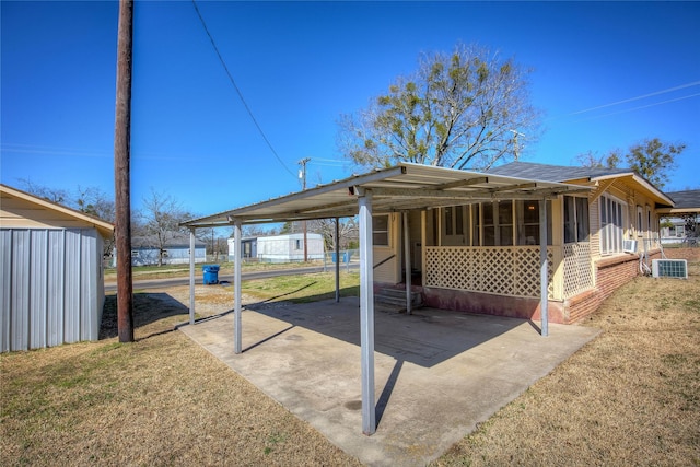 exterior space with entry steps, a sunroom, and a carport