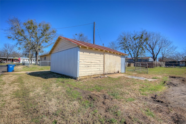 view of outbuilding featuring an outdoor structure and fence