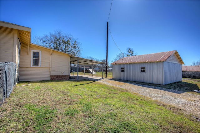 view of yard with an outbuilding and fence