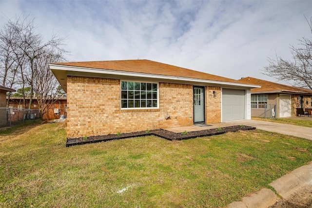 view of front facade with a garage, brick siding, fence, driveway, and a front yard