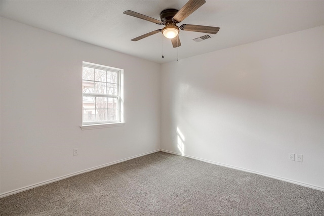 unfurnished room with a ceiling fan, baseboards, visible vents, and carpet flooring