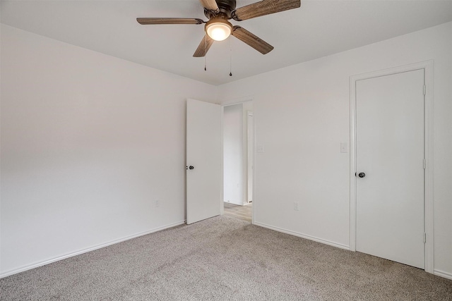 unfurnished bedroom featuring ceiling fan, baseboards, and light colored carpet