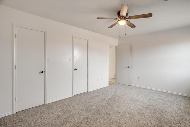 unfurnished bedroom with carpet floors and a ceiling fan