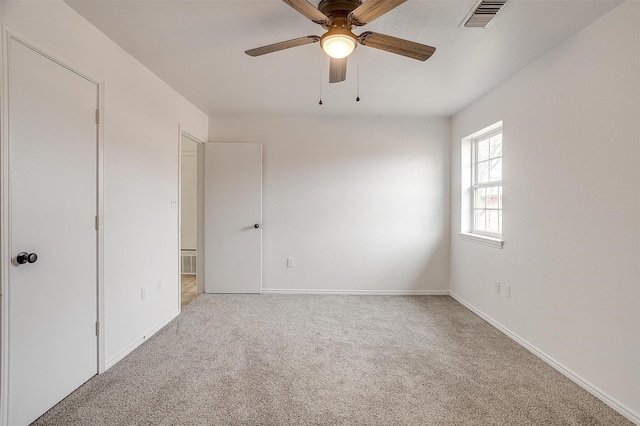 unfurnished bedroom featuring ceiling fan, carpet floors, visible vents, and baseboards