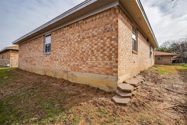 view of side of home featuring brick siding