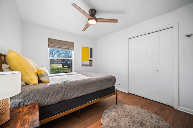 bedroom with a closet, ceiling fan, baseboards, and wood finished floors