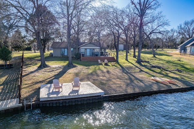 dock area featuring a water view and a lawn