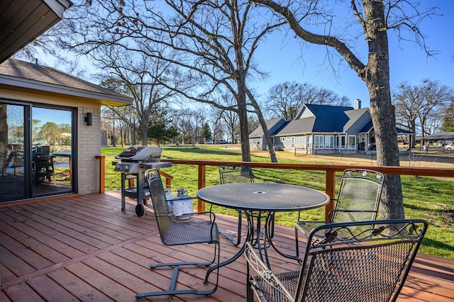 deck with grilling area and a lawn