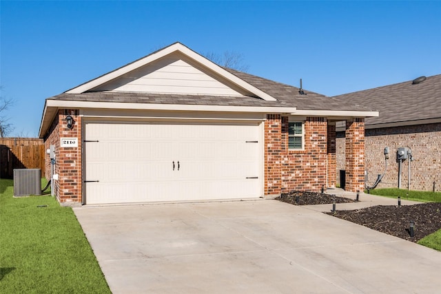 ranch-style home featuring central air condition unit, a garage, concrete driveway, and brick siding