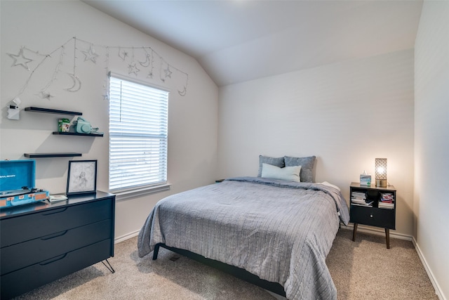 bedroom featuring light carpet, baseboards, and vaulted ceiling