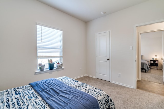 bedroom featuring carpet floors and baseboards