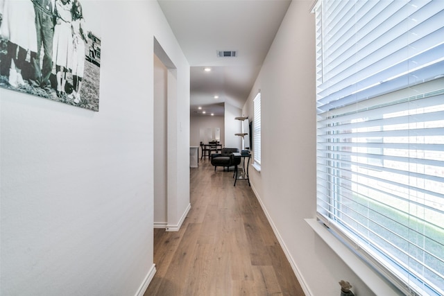 hall with recessed lighting, visible vents, baseboards, and wood finished floors