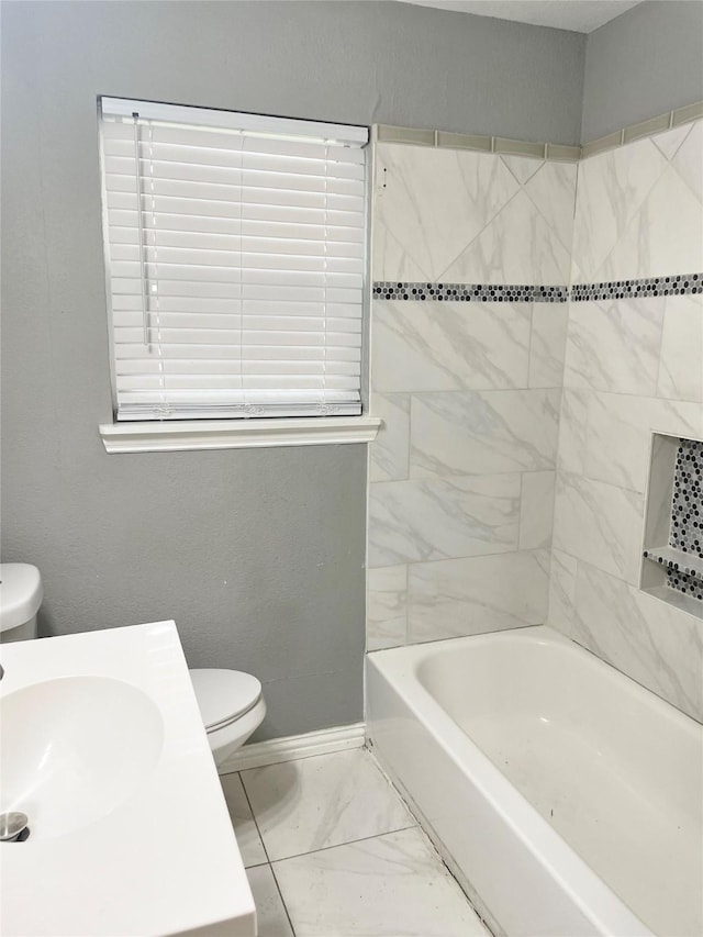 bathroom featuring marble finish floor, baseboards, a sink, and toilet