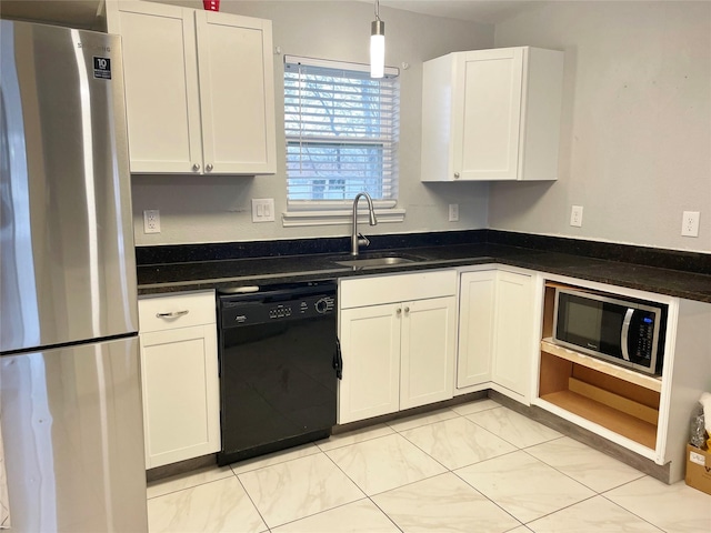 kitchen with white cabinetry, appliances with stainless steel finishes, a sink, and decorative light fixtures