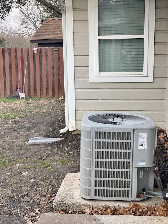 exterior details featuring cooling unit and fence