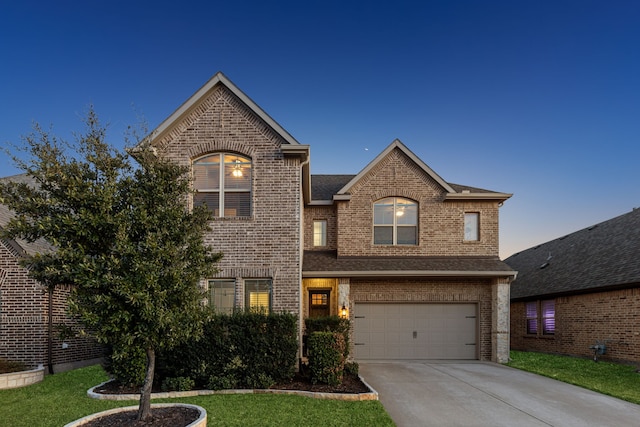 traditional home with a garage, brick siding, driveway, and roof with shingles