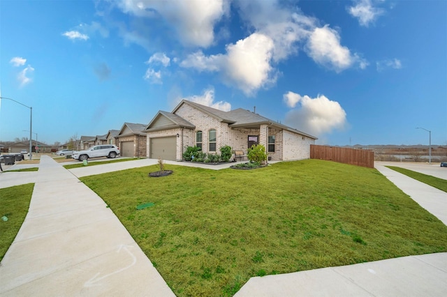 view of front of home with a garage, brick siding, fence, driveway, and a front yard