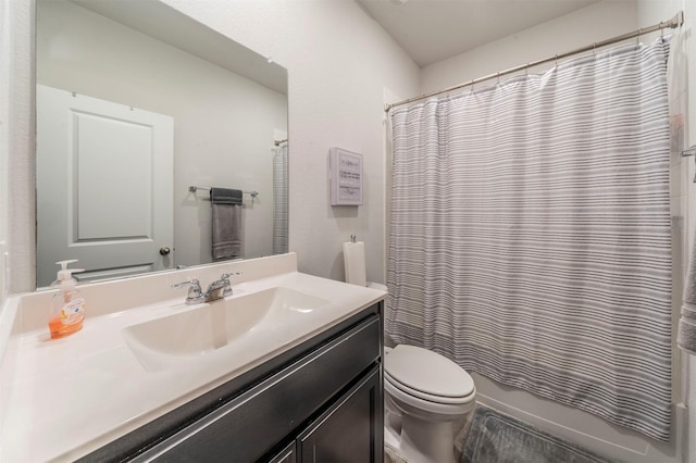 full bathroom featuring toilet, shower / tub combo with curtain, and vanity