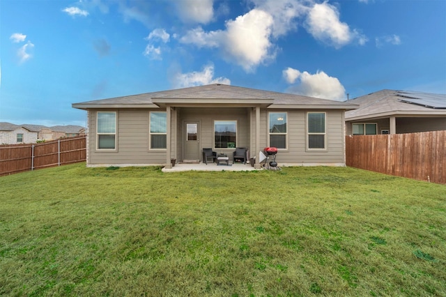 rear view of property with a patio area, a fenced backyard, and a yard