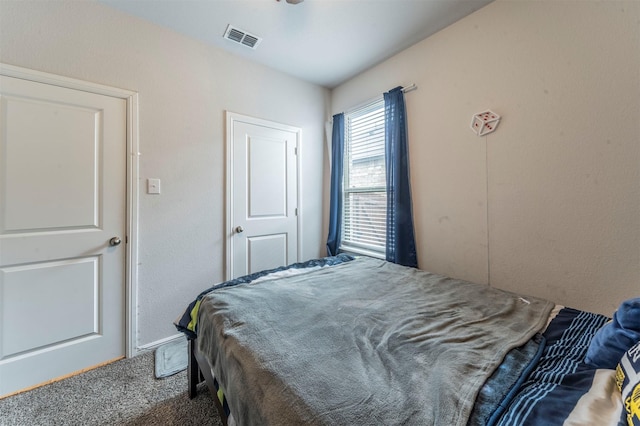 carpeted bedroom featuring visible vents