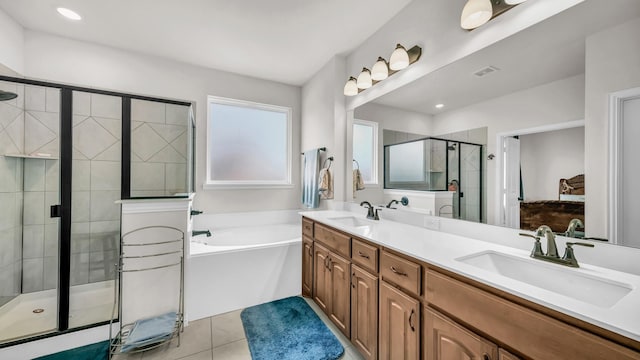 full bath with a bath, tile patterned flooring, a sink, and a shower stall