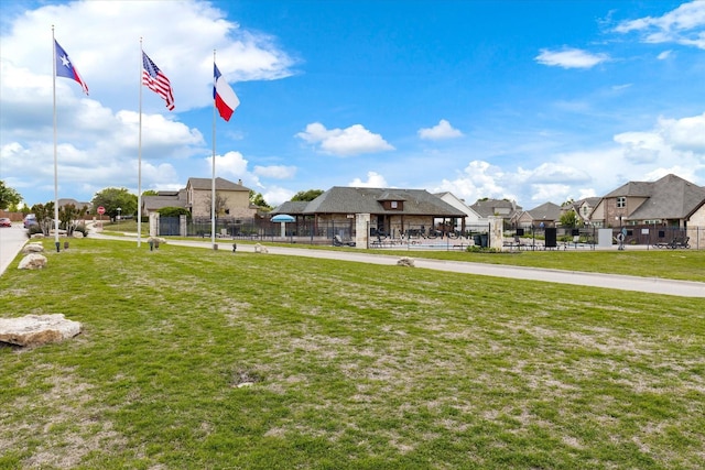 exterior space featuring a yard, a residential view, and fence