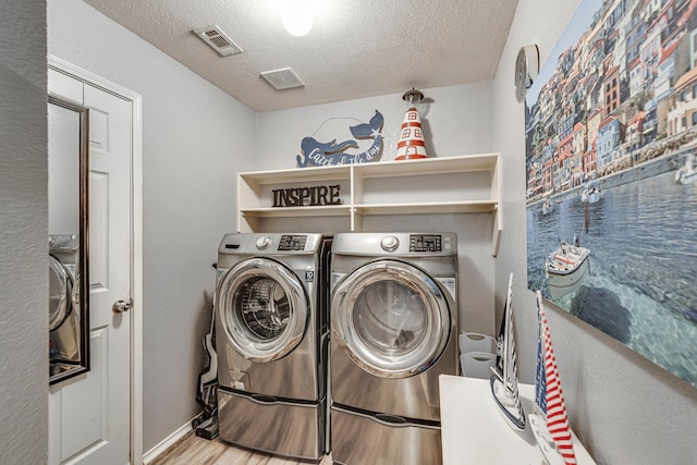 laundry area with laundry area, visible vents, a textured ceiling, and independent washer and dryer